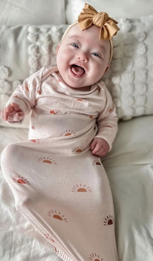 Sunrise Gown 2-Piece worn by baby with bow in her hair.