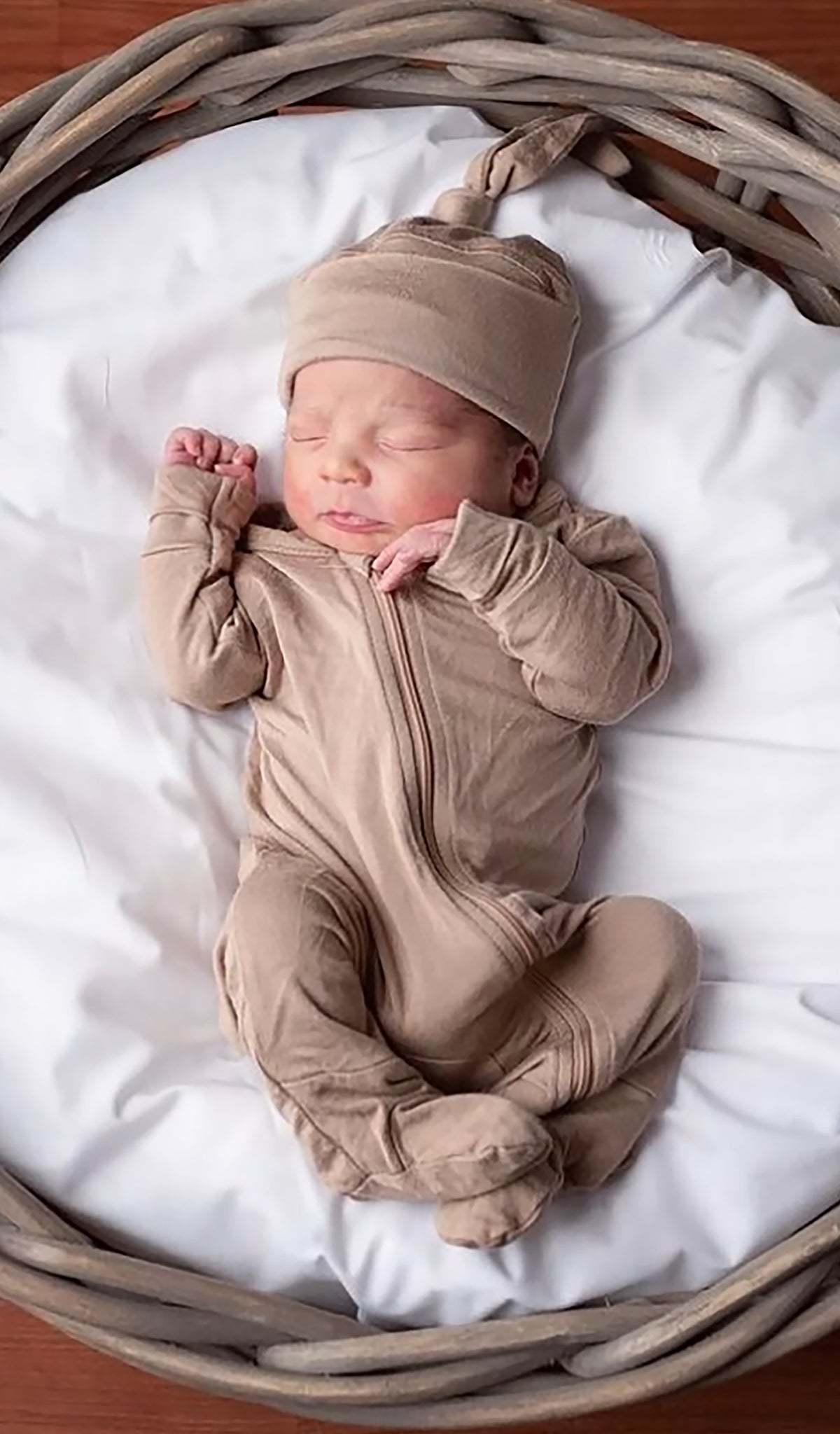 Footie 2-Piece - Latte worn by sleeping baby laying in a wicker basket.