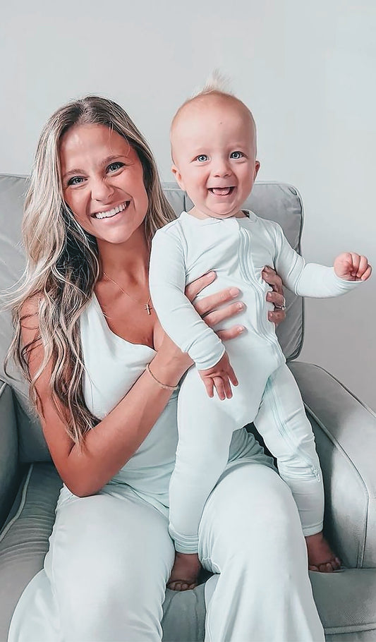 Whispering Blue Convertible Romper worn by baby boy, who is being held by his mom.