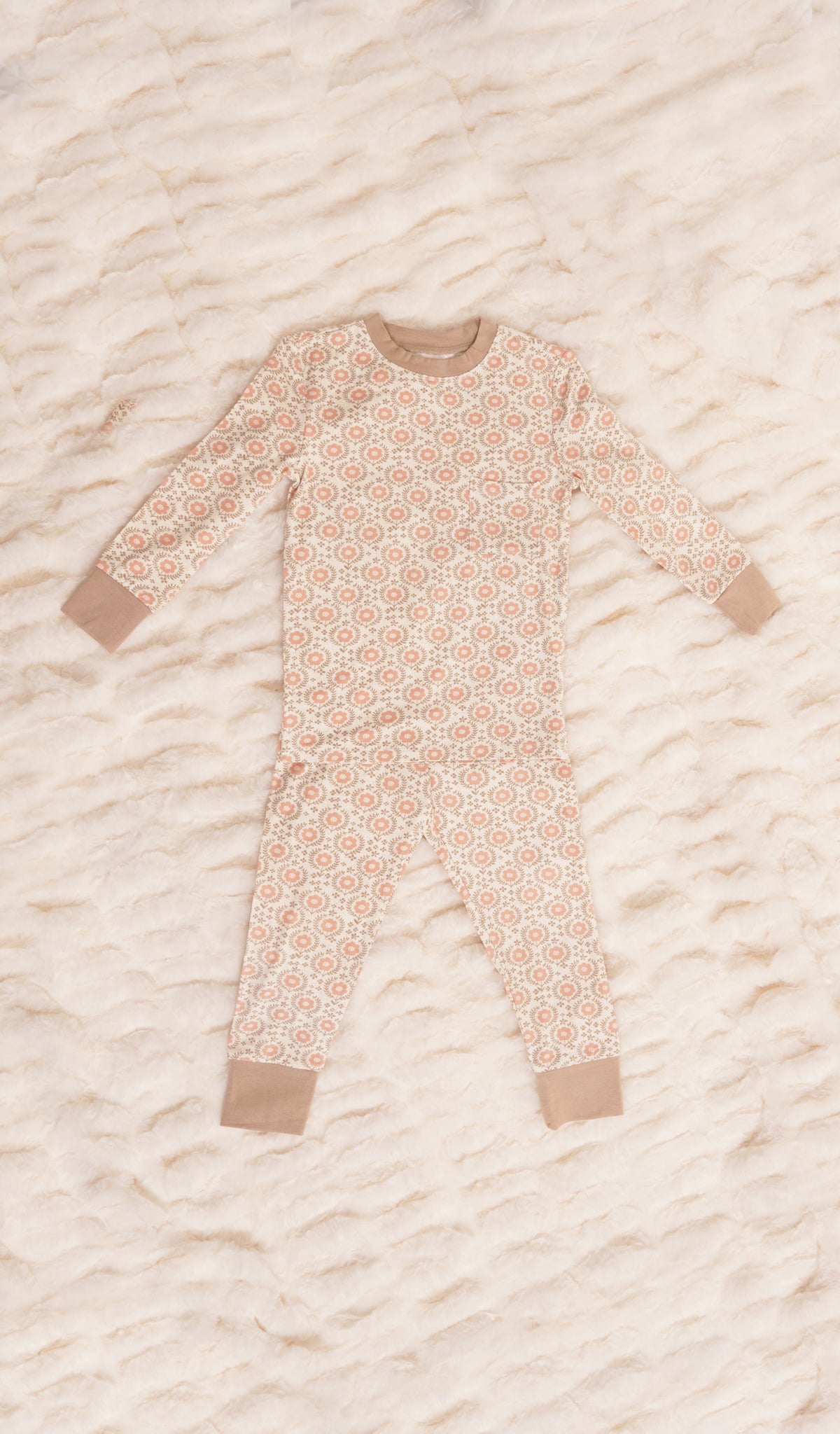 Bohemian Emerson Kids 2-Piece Pant PJ. Long sleeve top with cuff trim and long pant with cuff trim on a textured beige blanket.