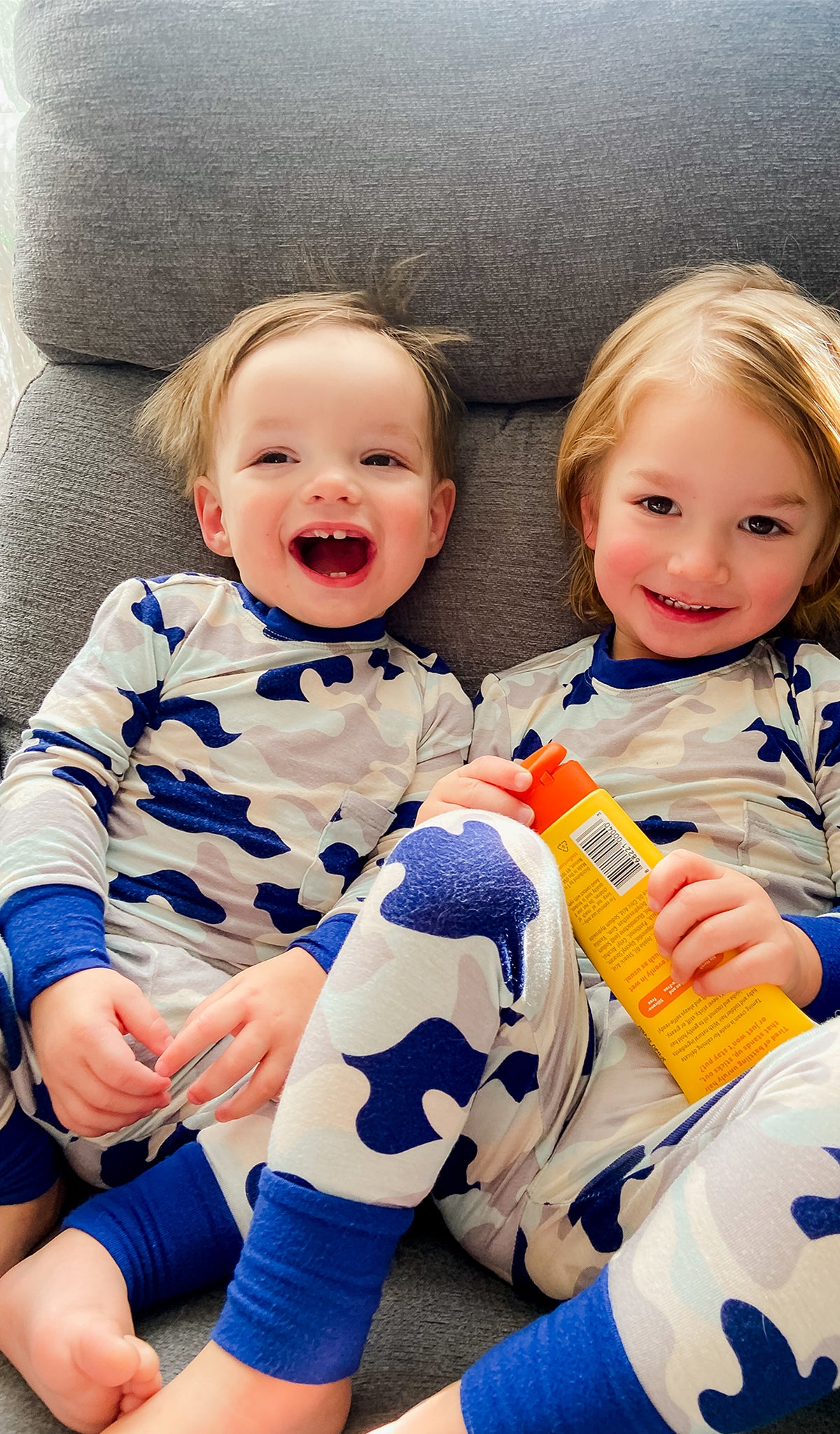 Camo Emerson Baby 2-Piece Pant PJ worn by baby boy sitting next to his big brother in matching PJs.