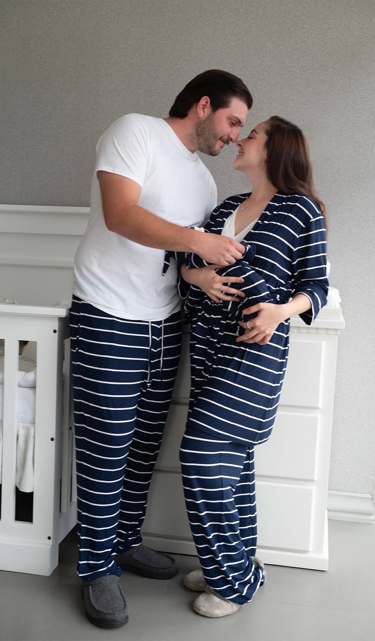 Navy Stripe Oliver Mens pants worn by father standing next to his wife and baby.