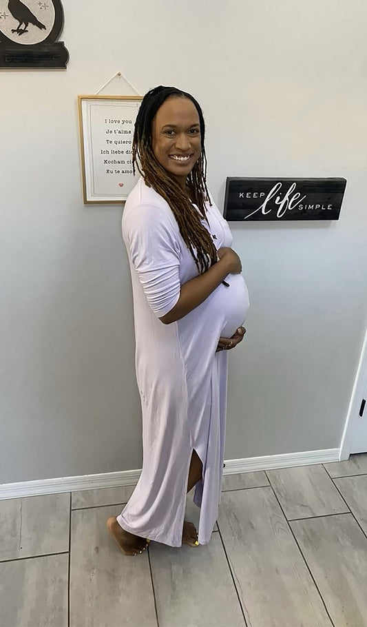 Lavender Juliana dress worn by woman cradling her belly.