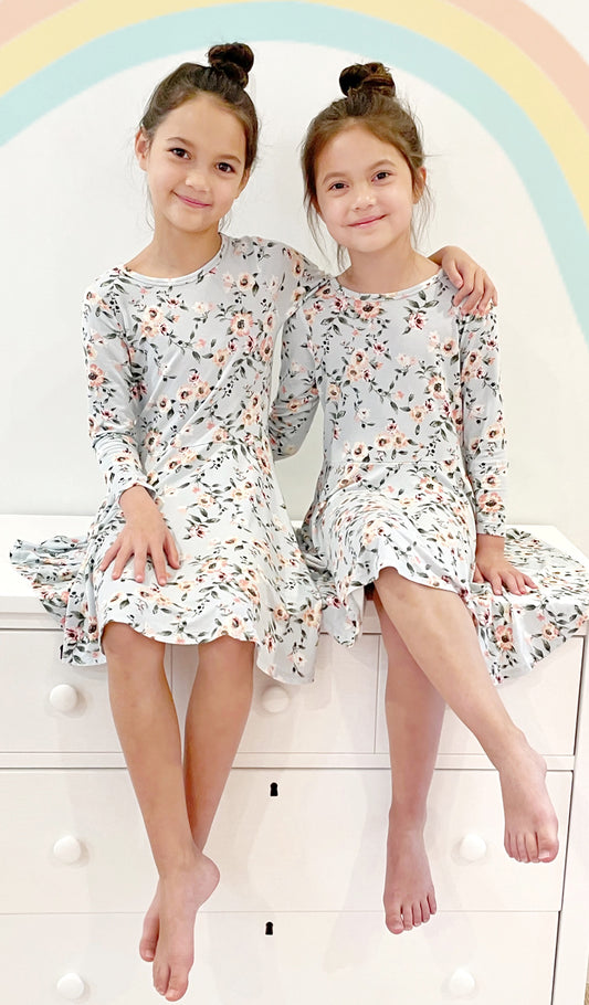 Cloud Blue Kendyl Kids Twirly Dress worn by sisters sitting on top of their dresser.
