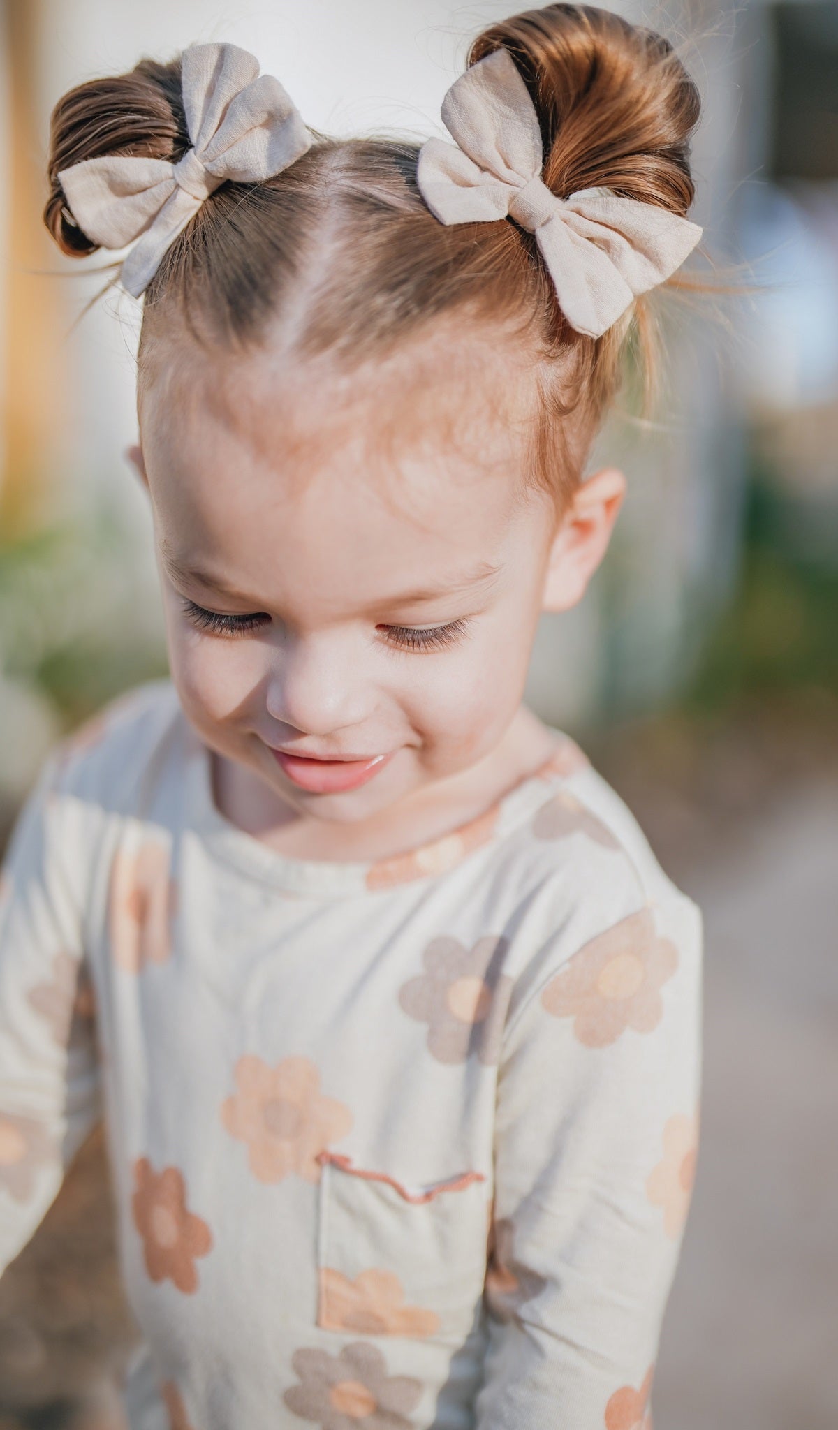 Close up crop shot of Daisies Charlie Baby 3-Piece Pant PJ worn by little girl.