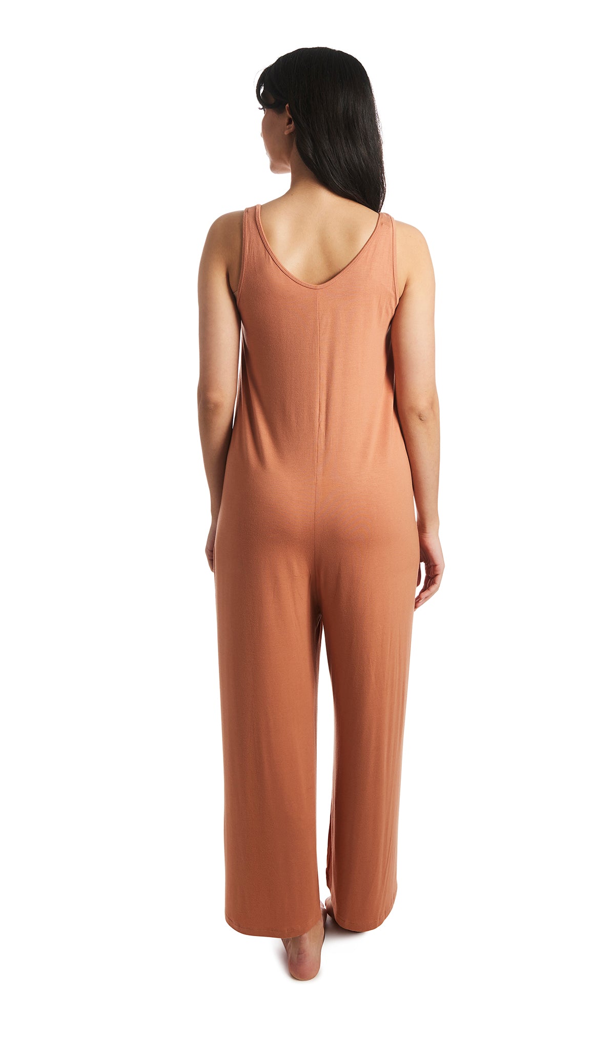 Sandstone Luana romper. Back shot of woman wearing sleeveless wide-leg romper with arms down to side.