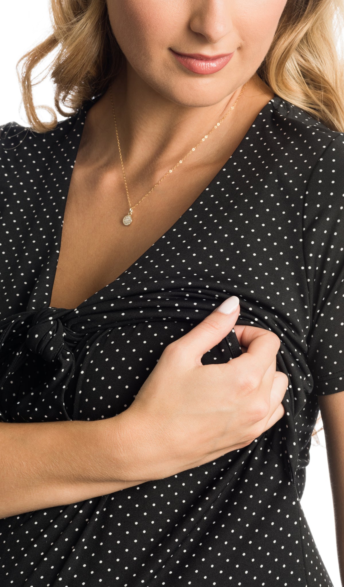 Black Dot Jada dress detail shot of woman pulling up crop front panel to access nursing.