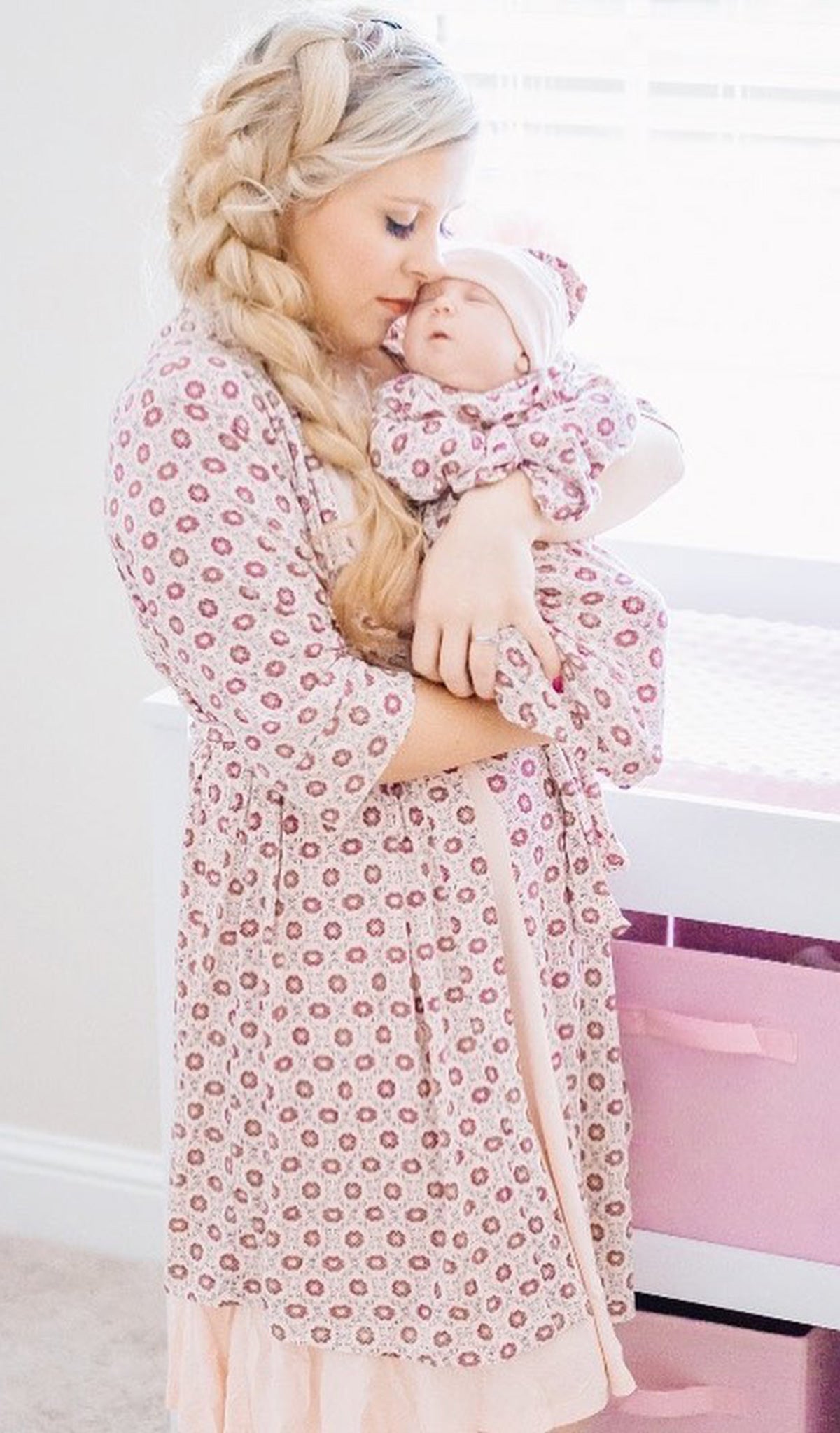 Pink Blush Dawn Chemise/Robe worn by woman holding baby in matching gown and hat set.