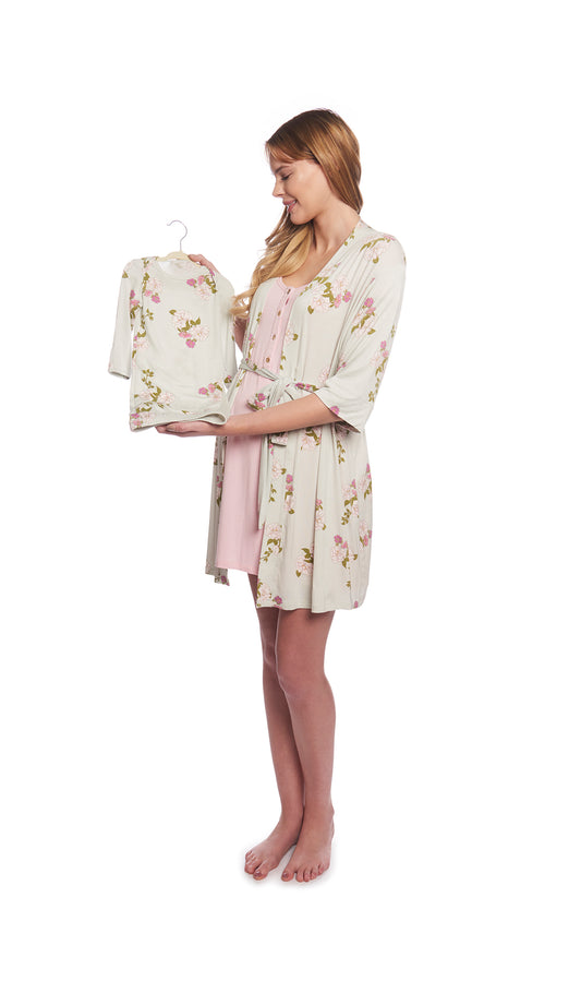 Peony Carolyn 4-Piece Set, pregnant woman wearing short sleeve night gown and robe while holding baby gown on a hanger.