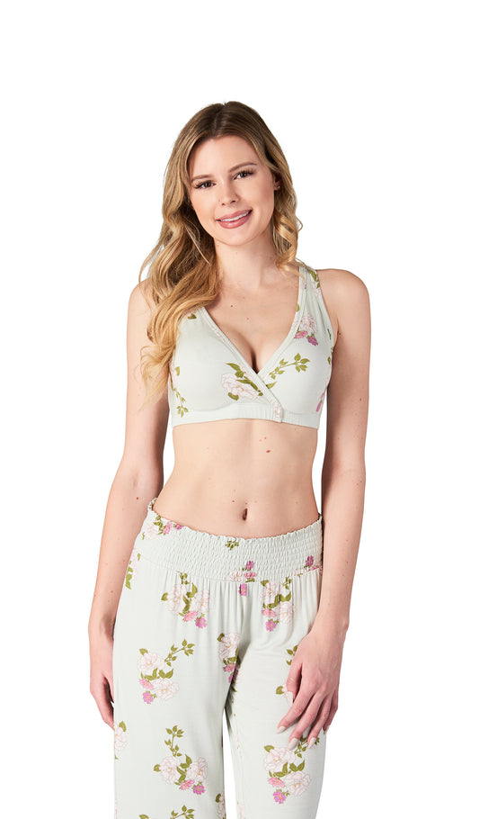 Woman wearing a floral top and pants on a white background