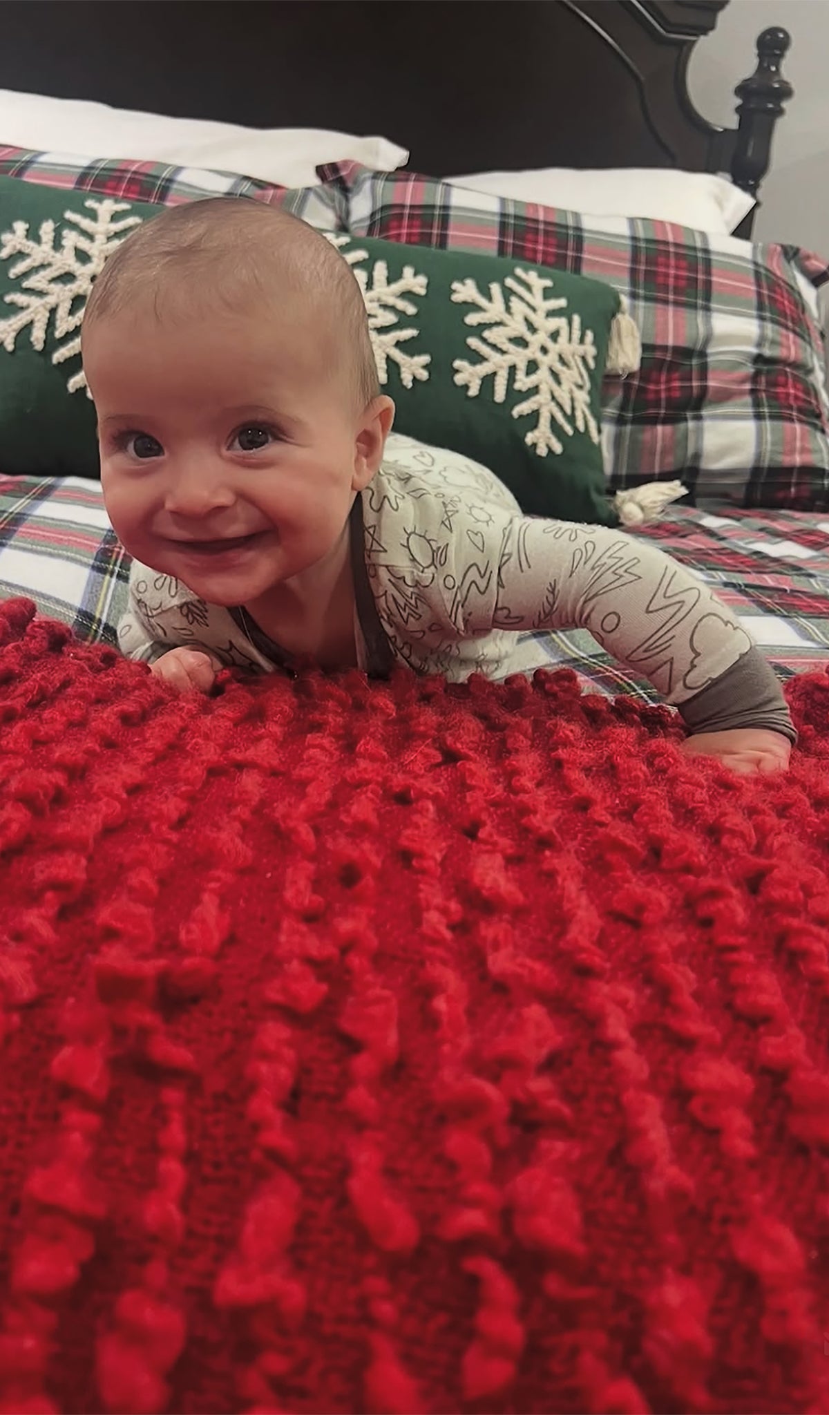 Sage Doodle Convertible Romper worn by baby laying on red blanket.