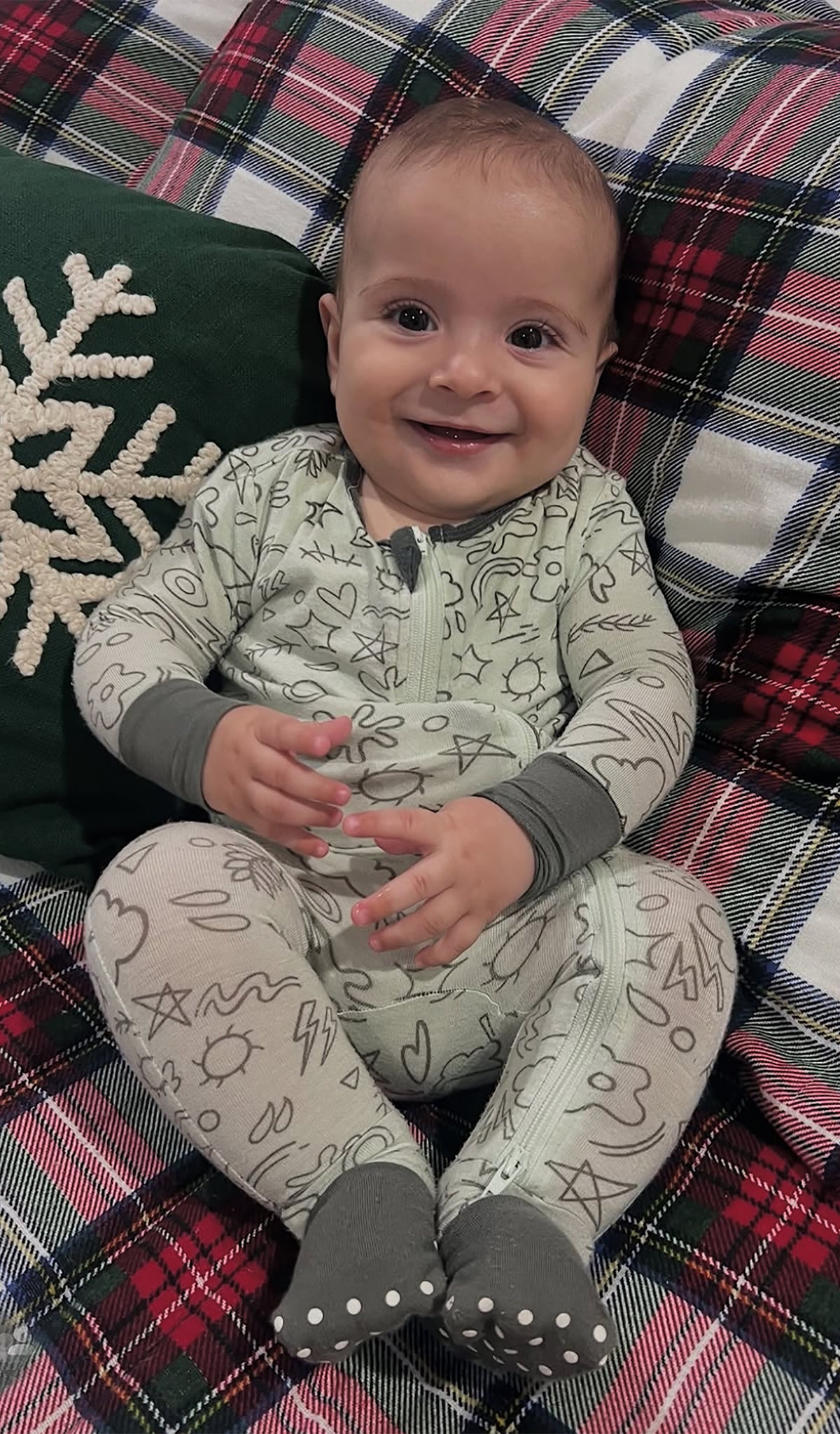 Sage Doodle Convertible Romper worn by baby laying on plaid blanket.