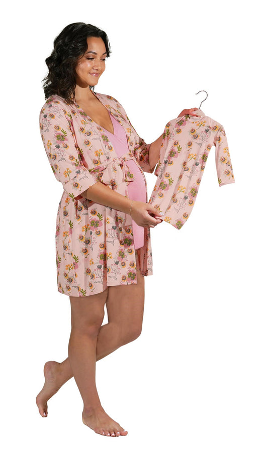 Camellia Adaline 5-Piece Set. Pregnant woman wearing 3/4 sleeve robe, tank top and short while holding a baby gown.