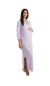 Lavender Juliana dress. Front shot of pregnant woman wearing long sleeve caftan with one hand on her belly.