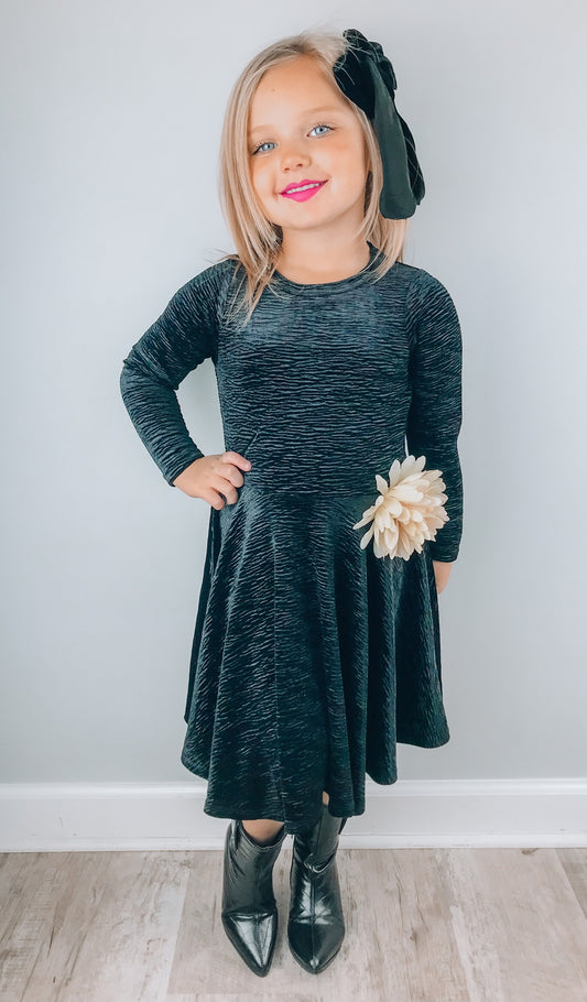 Black Kendyl Kids Twirly Dress worn by little girl with black bow in her hair.