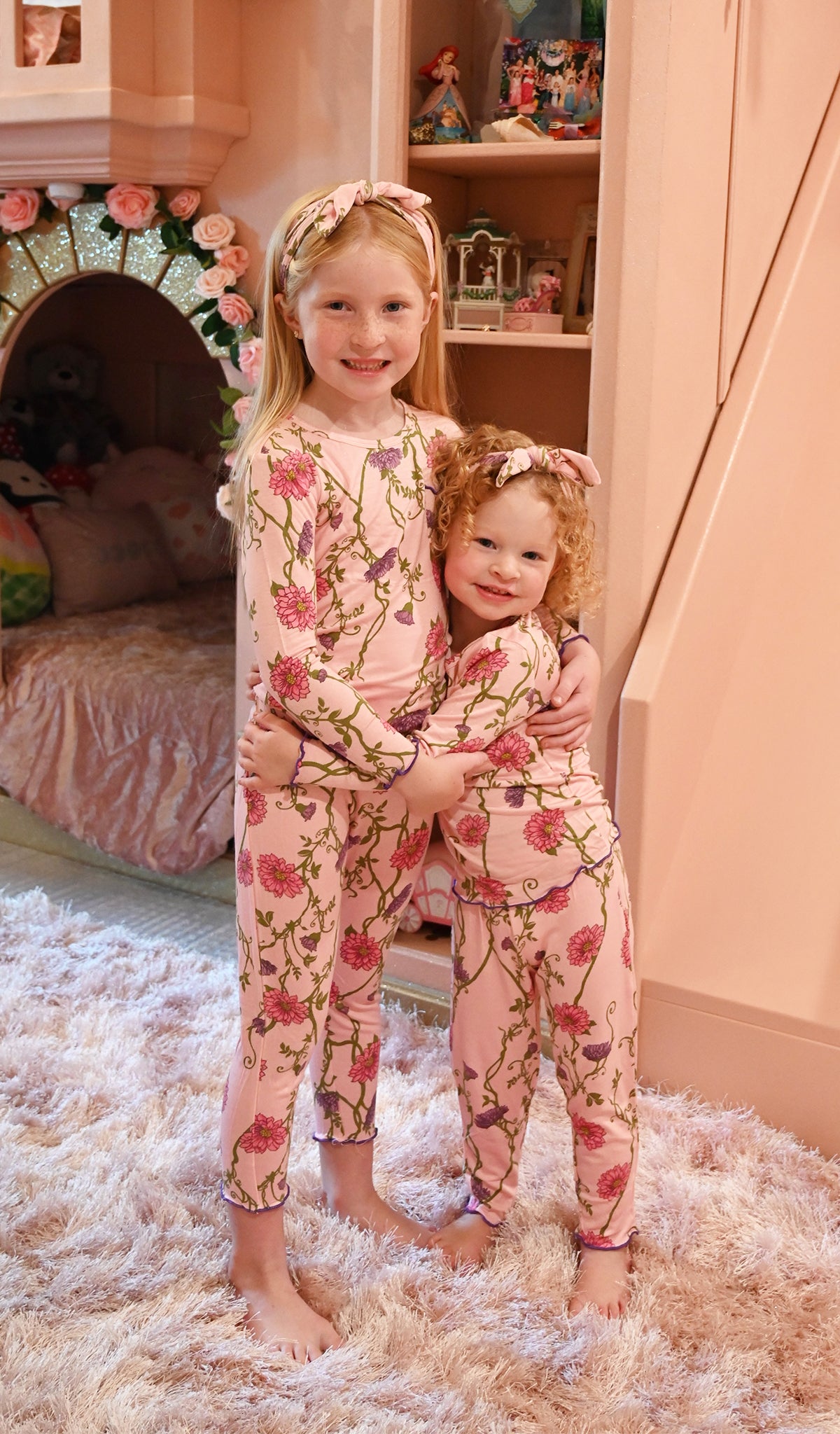 Dahlia Charlie Kids 3-Piece Pant PJ worn by little girl hugging her baby sister, who is also wearing the same PJ.
