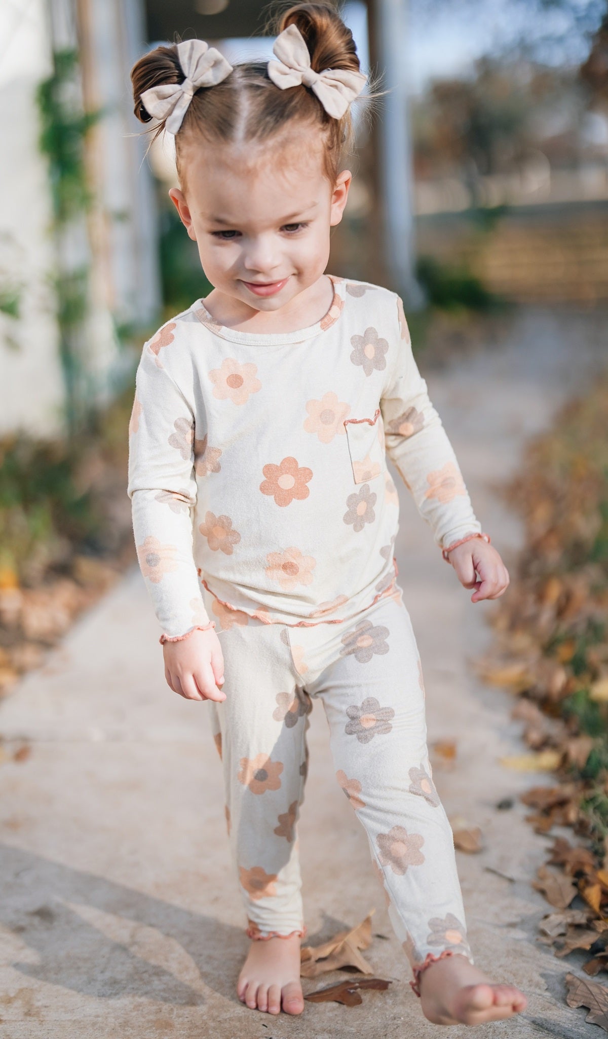 Daisies Charlie Baby 3-Piece Pant PJ worn by little girl walking barefoot.
