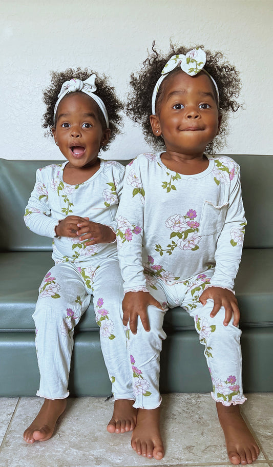 Peony Charlie Baby 3-Piece Pant PJ worn by twin baby girls sitting on couch.