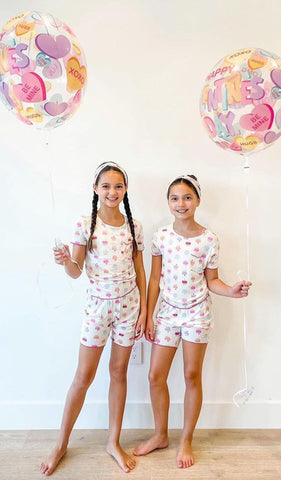 Cupcakes Bella Kids 3-Piece Short PJ worn by twin sisters, each holding a balloon.
