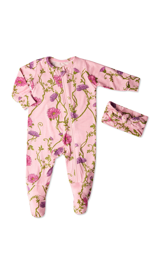 Dahlia Footie 2-Piece Set. Flat shot of zip front footie for baby with matching headwrap tied into a tie-knot bow.