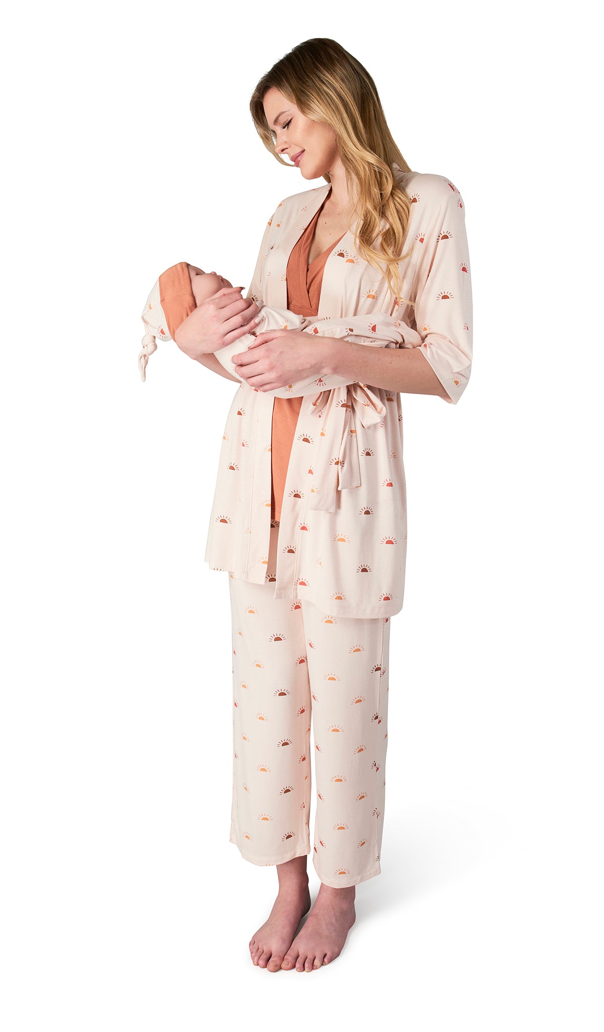 Sunrise Analise 5-Piece Set. Woman wearing 3/4 sleeve robe, tank top and pant while holding a baby wearing baby gown and knotted baby hat.