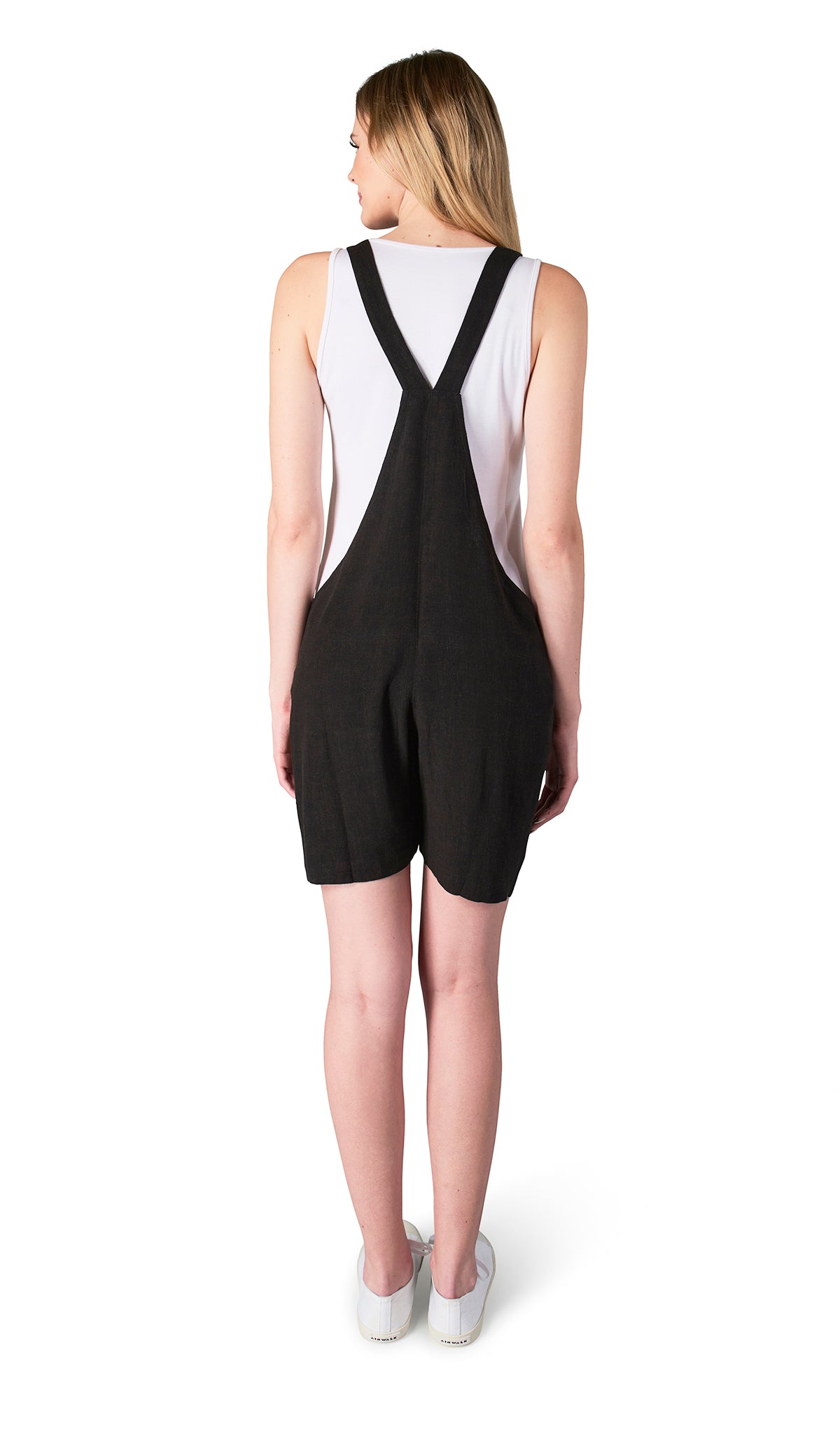 Black Jodi overall back shot worn by woman with white tank top layered underneath.