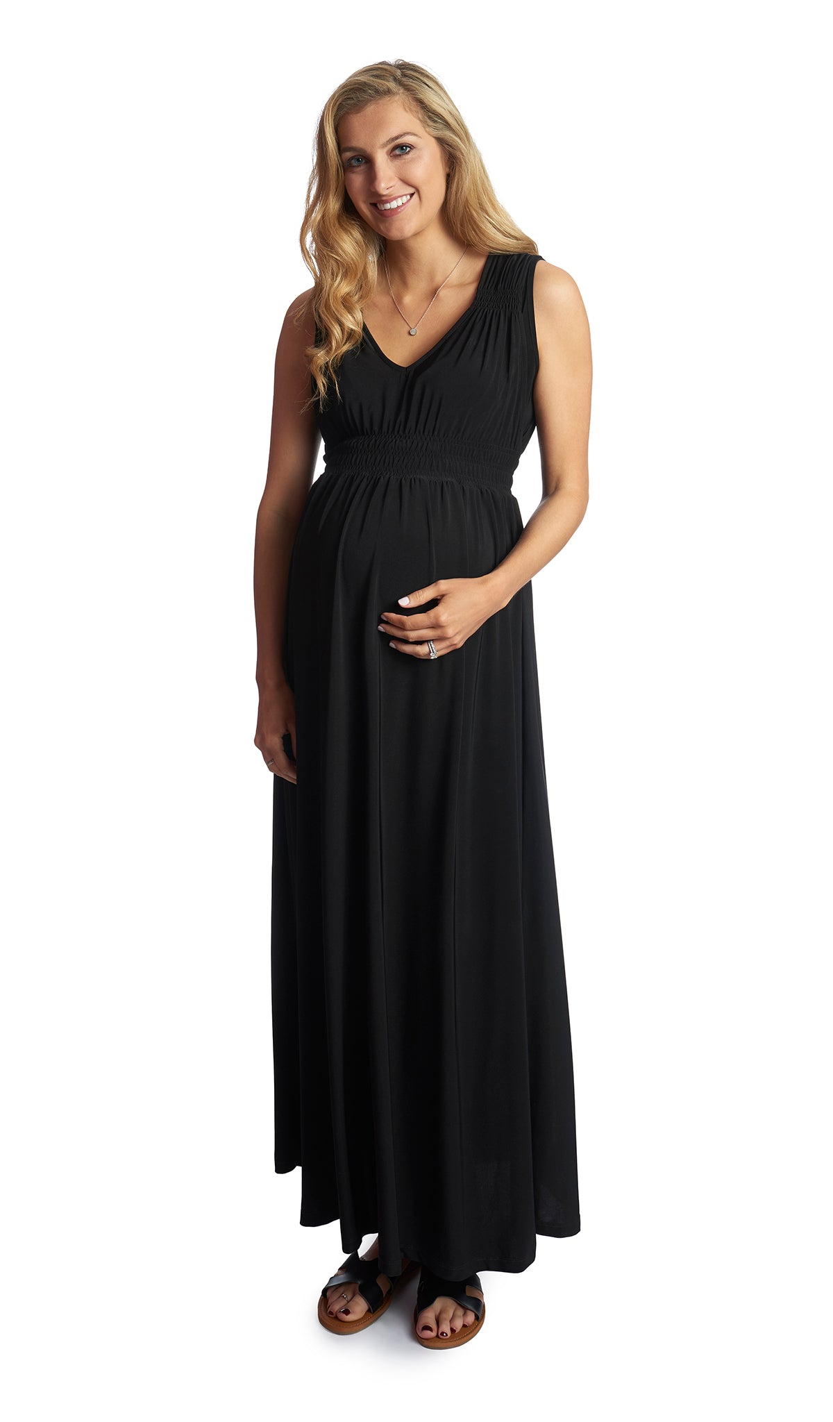 Black Valeria dress worn by pregnant woman with one hand on her belly.