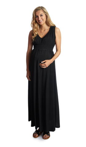Black Valeria dress worn by pregnant woman with one hand on her belly.