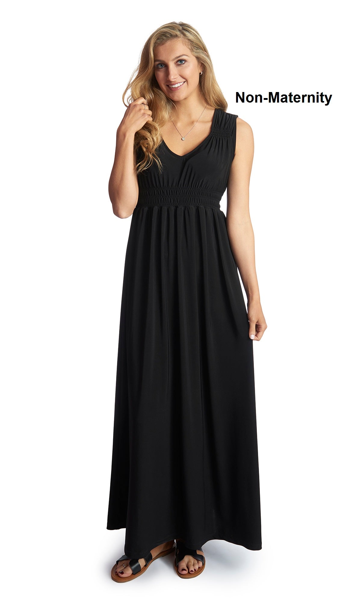 Black Valeria dress worn as non-maternity style by woman with one hand touching her hair.