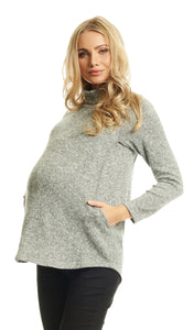 Heather Grey Teresa Sweater. Pregnant woman wearing Teresa Sweater with one hand inside nursing pocket opening.