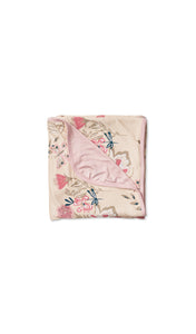 Wild Flower Swaddle Blanket folded into a square with print showing on one side and reversible contrast solid showing on other side of fold down flap.