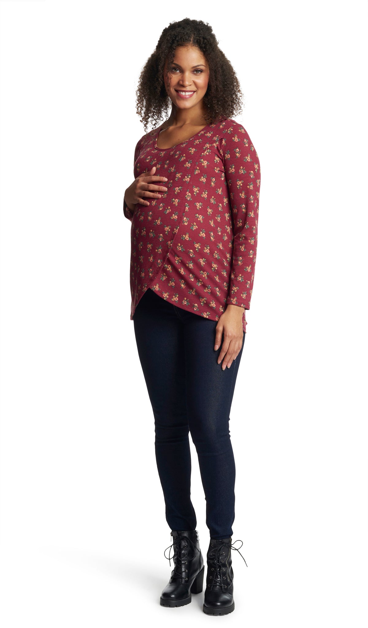 Burgundy Ditsy Adriana top worn in full length shot by pregnant woman with dark denim jeans and black boots and with one hand on her belly.