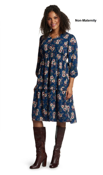 Blue Floral Jenny Dress. Woman wearing Jenny dress as non-maternity with one hand touching the side of her face.