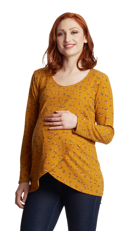 Mustard Ditsy Adriana top worn in cropped shot by pregnant woman with dark denim jeans and with one hand on her belly.