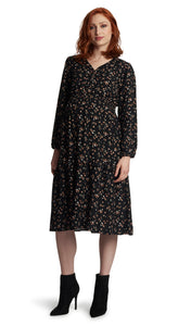 Black Floral Jenny Dress. Pregnant woman wearing Jenny dress and knee high burgundy boots.