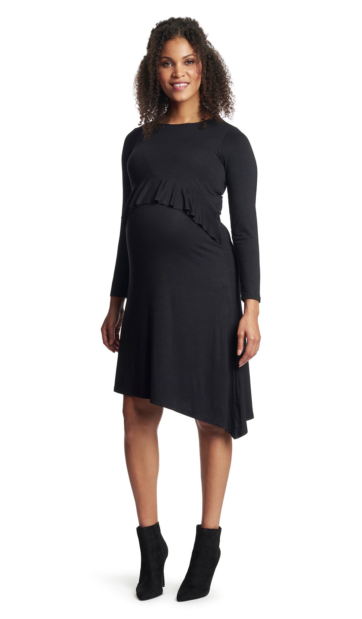 Black Melissa dress worn by pregnant woman with arms down next to side.