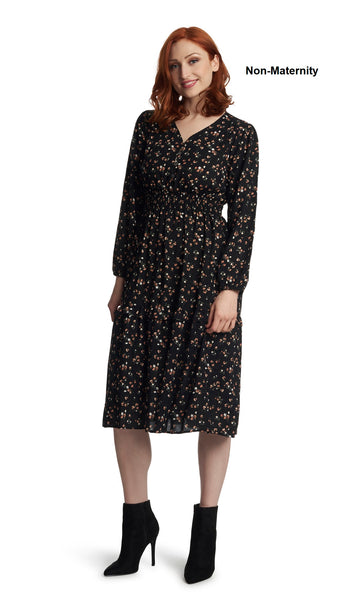 Black Floral Jenny Dress. Woman wearing Jenny dress as non-maternity with one hand touching the side of her face.