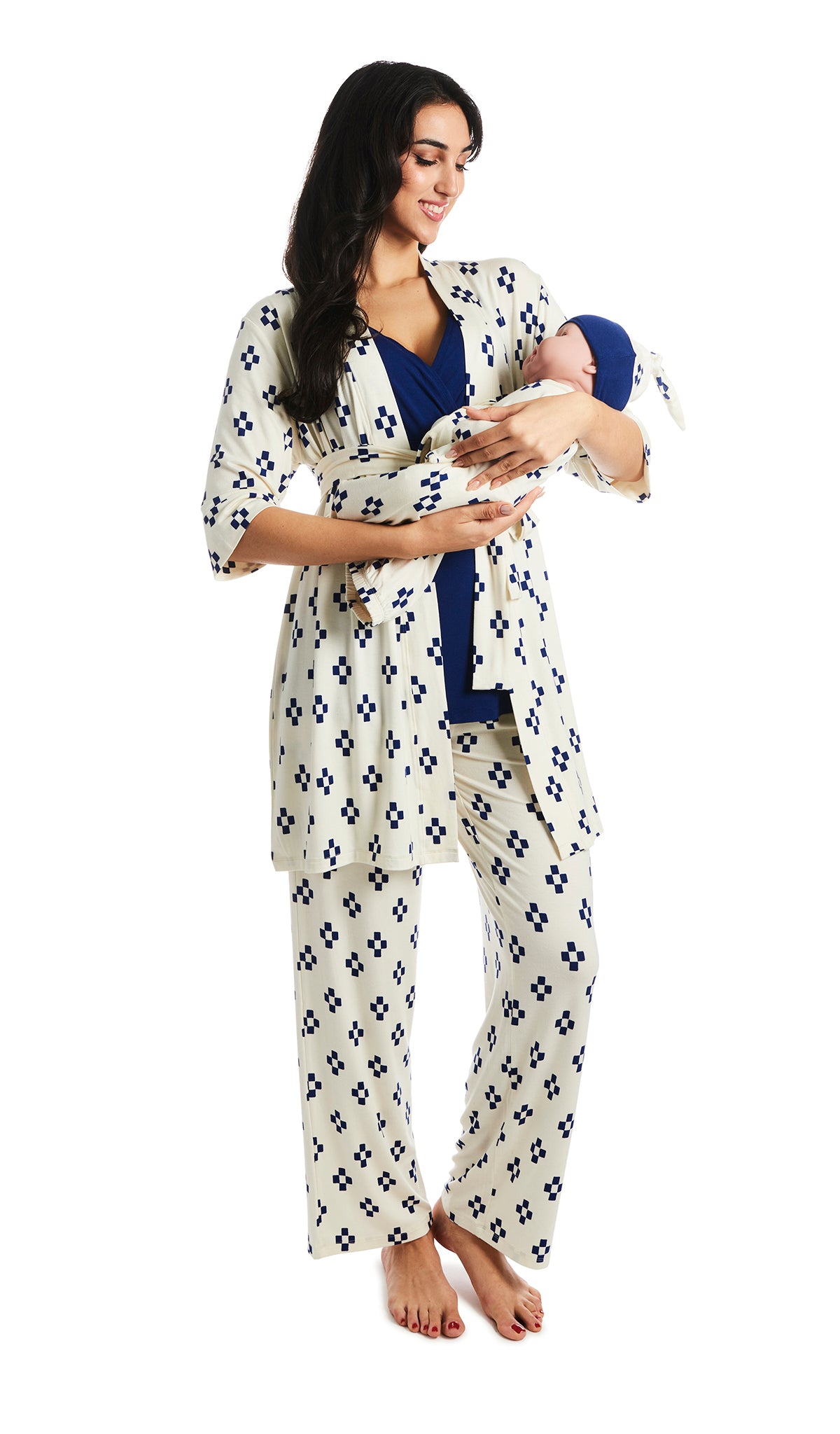 Geo Analise 5-Piece Set. Woman wearing 3/4 sleeve robe, tank top and pant while holding a baby wearing baby gown and knotted baby hat.