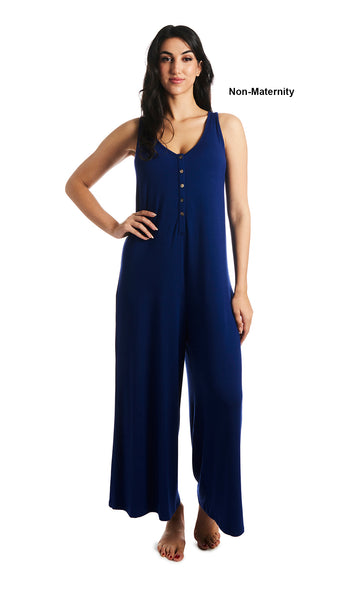 Denim Blue Luana romper. Woman wearing sleeveless wide-leg romper with scoop-neckline with button-front placket as non-maternity with one hand resting on hip.