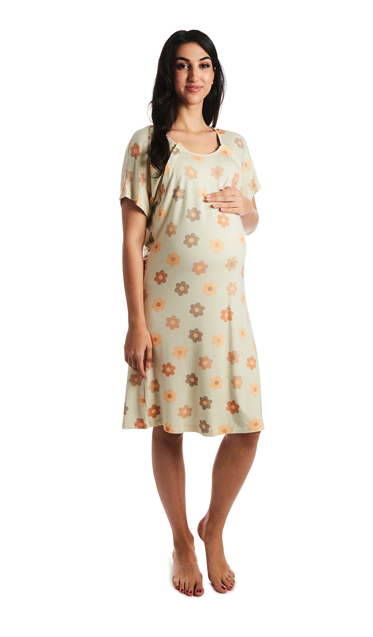Daisies Rosa hospital gown. Pregnant woman with one hand on belly, wearing hospital gown with scoop-neckline featuring dual snap openings. 