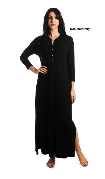 Black Juliana dress. Woman wearing caftan as non-maternity style featuring long sleeve button-up V-neckline with band collar and a maxi-length hem with airy side slits. One hand is resting on hip and other arm down to side.