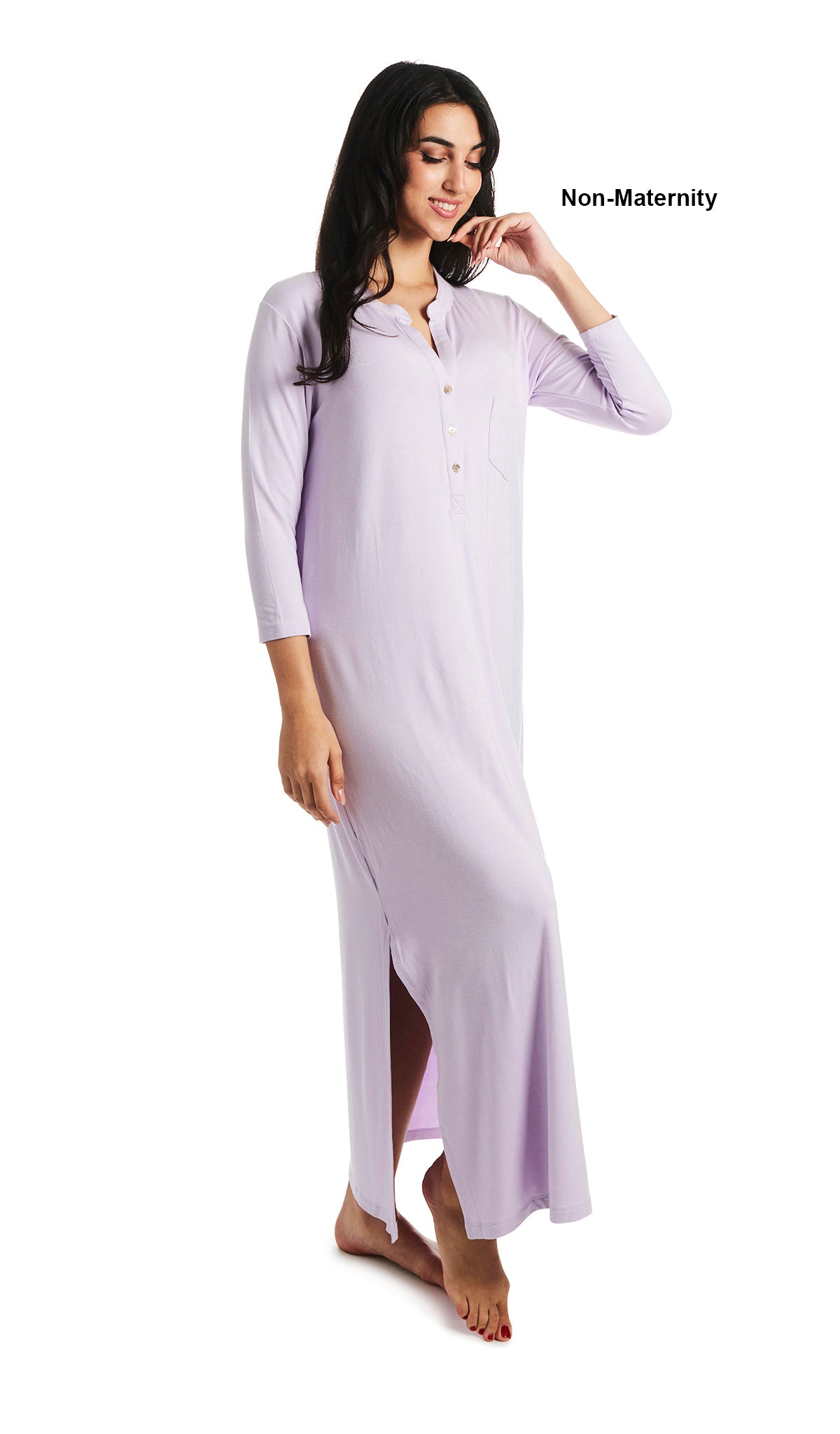 Lavender Juliana dress. Woman wearing caftan as non-maternity style featuring long sleeve button-up V-neckline with band collar and a maxi-length hem with airy side slits. One hand is down to side with fingers of other hand touching chin. 