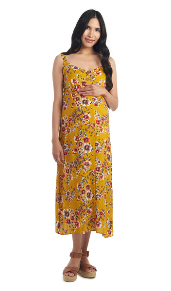 Rust Floral Savannah dress worn by pregnant woman smiling with one hand on her belly.