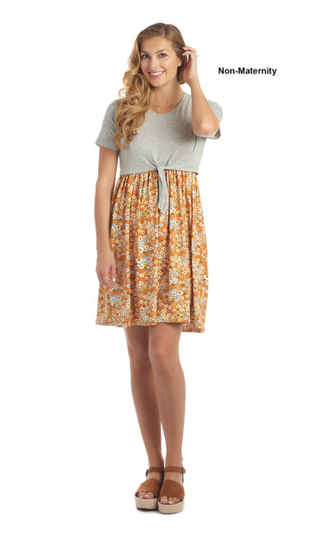Sienna Floral Lehua 2-piece dress worn by woman as non-maternity style while one hand is touching her hair.