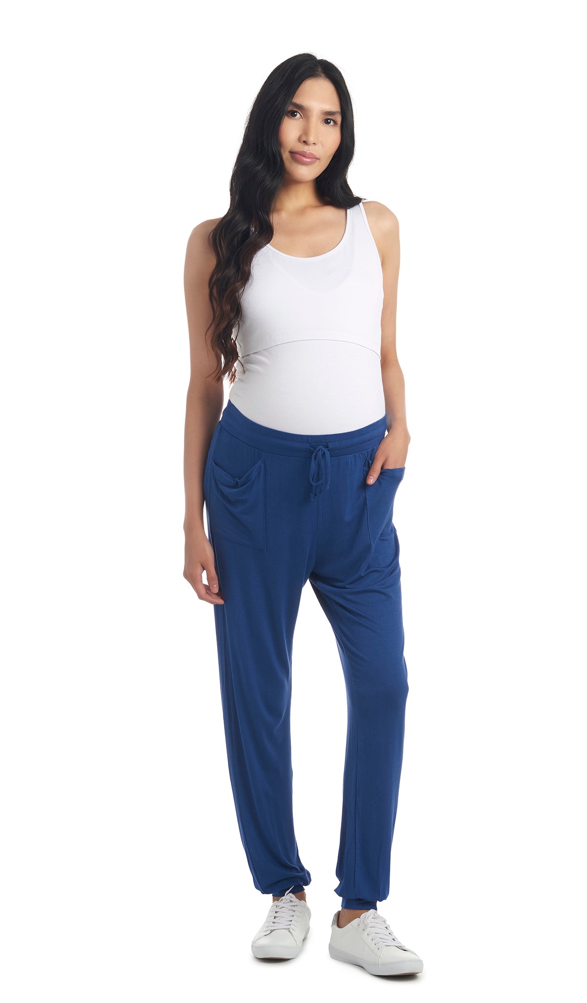 Denim Blue Carmen Jogger on pregnant woman wearing white Kara Tank and with one hand in front pocket of pant.