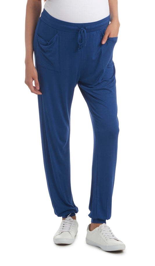 Denim Blue Carmen Jogger on figure, waist down with two front pockets, elastic drawstring waist and cuff hem.