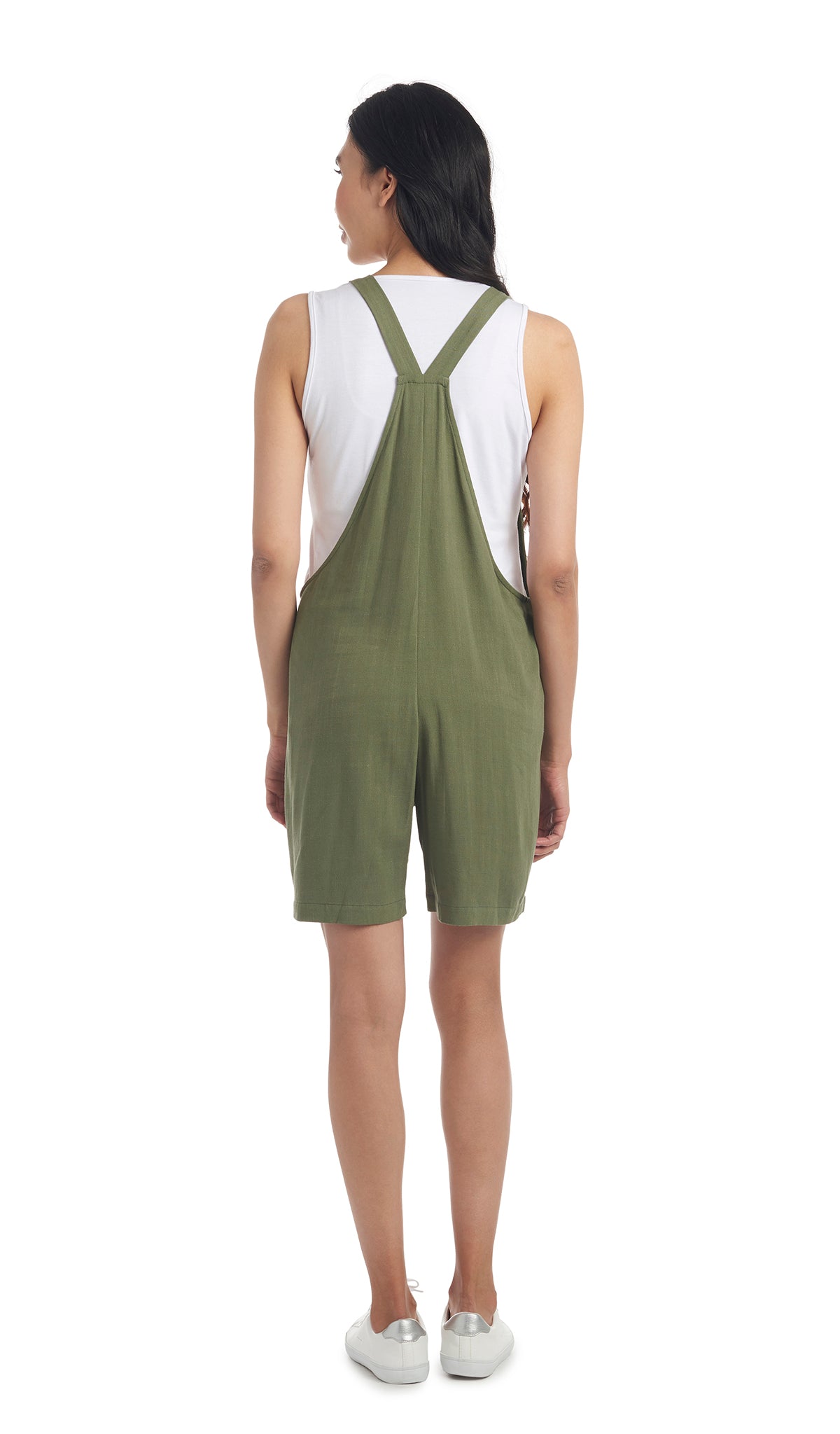 Olive Jodi overall back shot worn by woman with white tank top layered underneath.