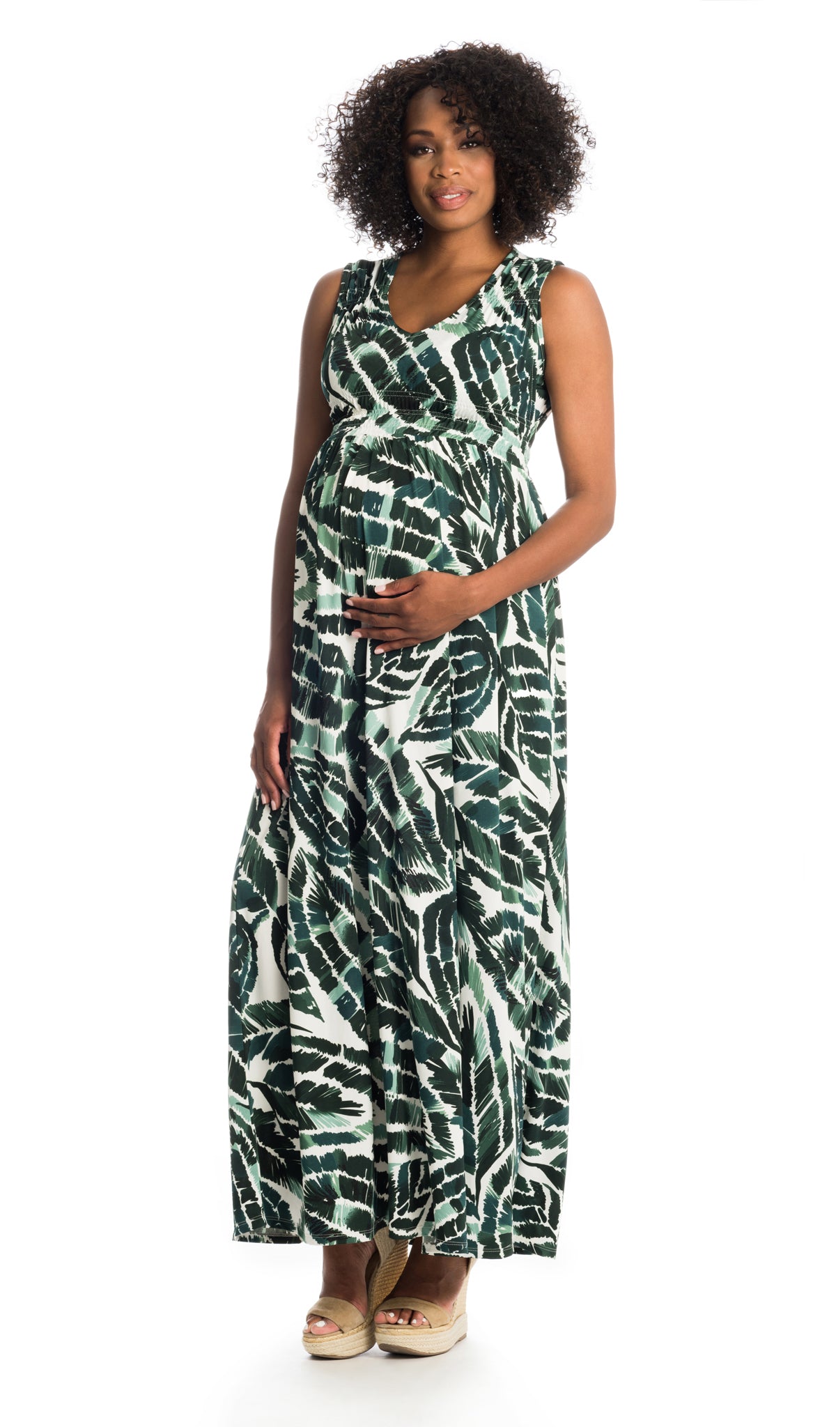 Palm Valeria dress worn by pregnant woman with one hand on her belly.