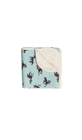 Horse Swaddle Blanket folded into a square with print showing on one side and reversible contrast solid showing on other side of fold down flap.
