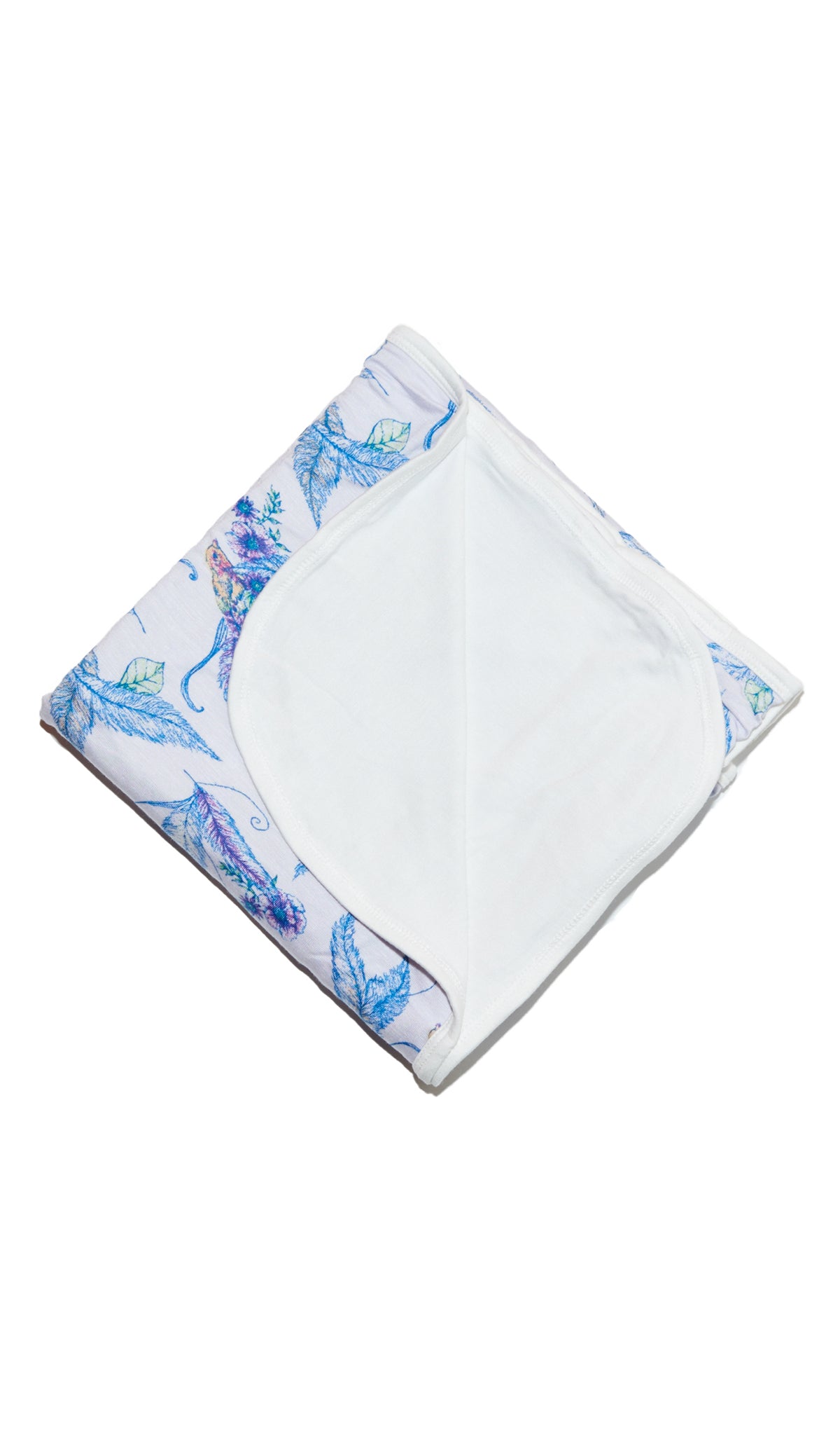 Sparrow Swaddle Blanket folded into a square with print showing on one side and reversible contrast solid showing on other side of fold down flap.